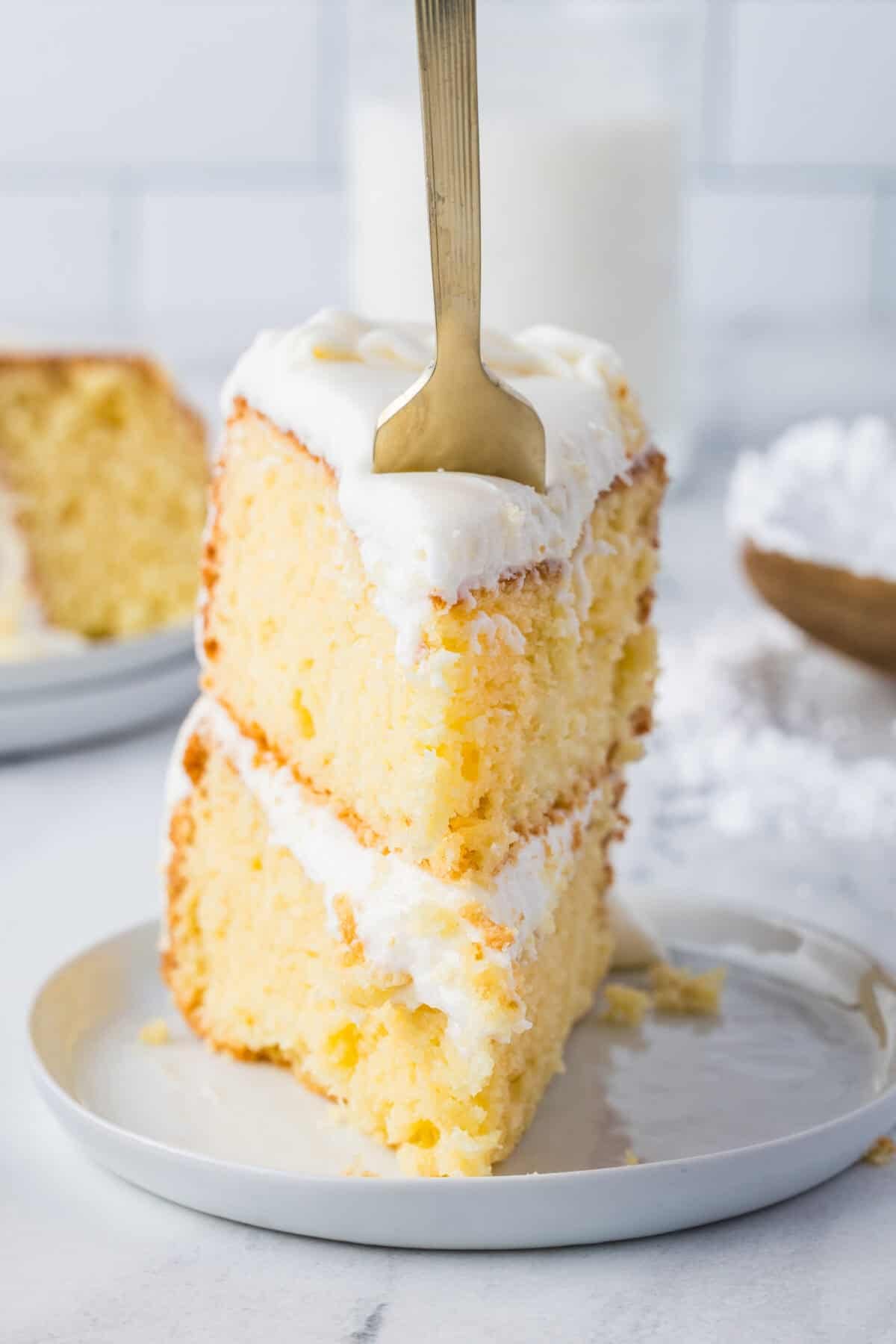 slice of wedding cake with a fork in it