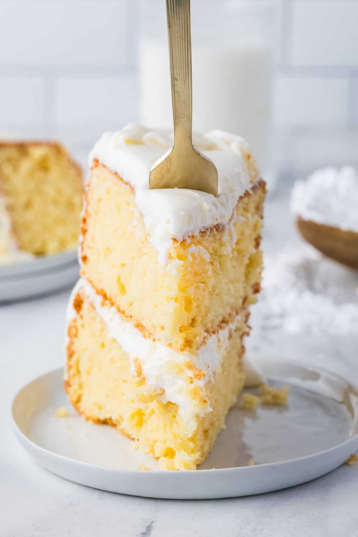 slice of wedding cake with a fork in it
