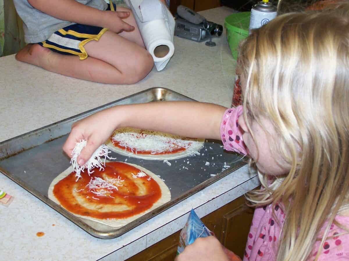 sarah making tortilla pizza