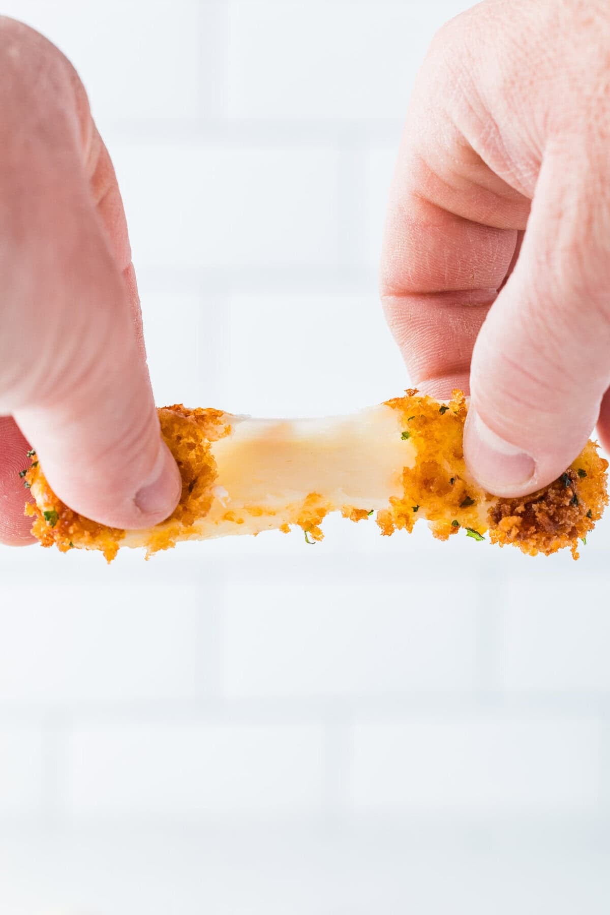 pulling cheese stick in half - great cheese pull