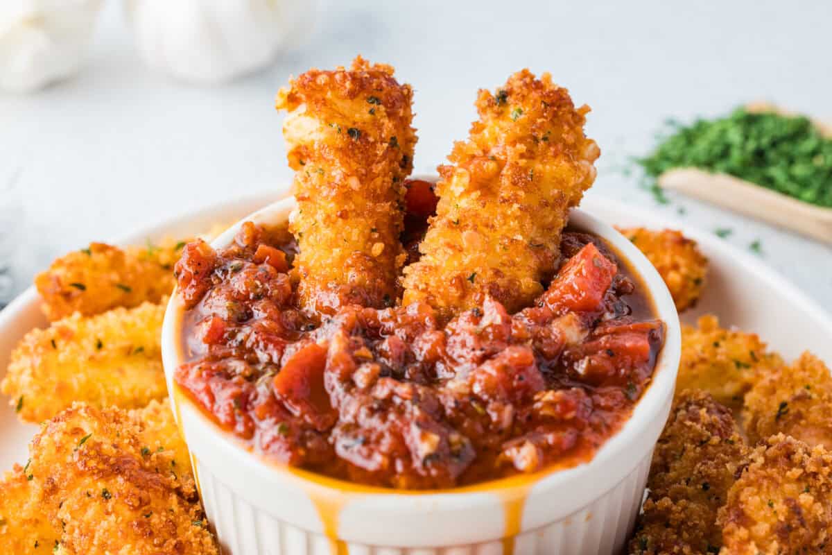 homemade mozzarella cheesesticks in marinara sauce