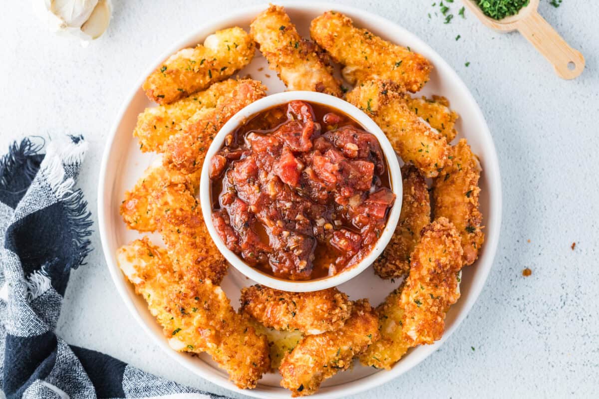 homemade mozzarella cheesesticks and a bowl of homemade marinara