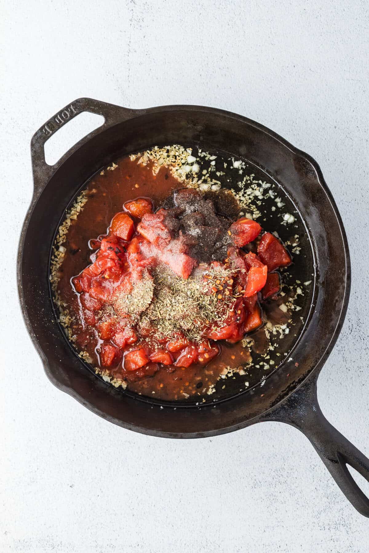 tomatoes and other seasonings added to skillet