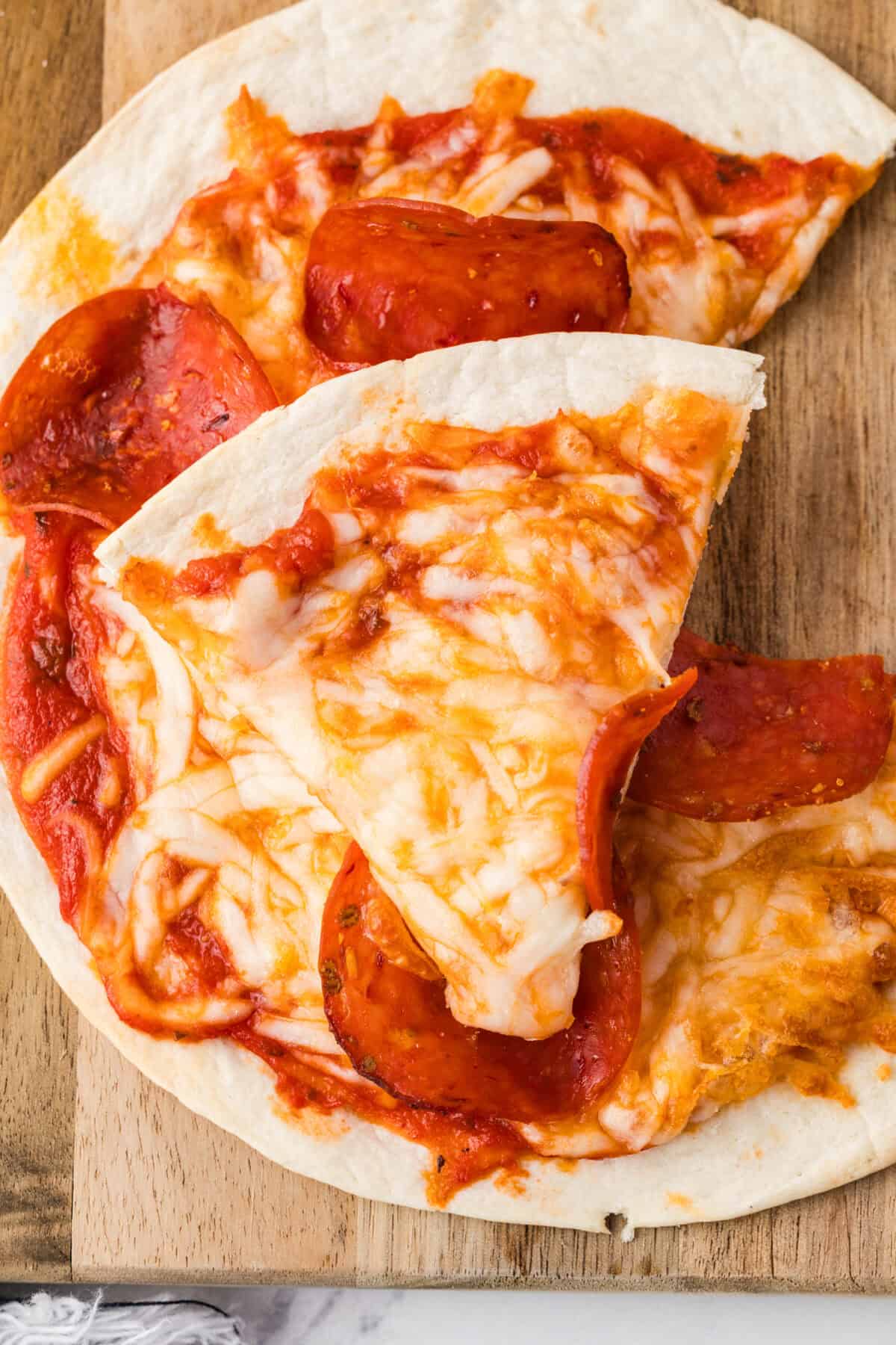sliced air fryer pizza on a cutting board