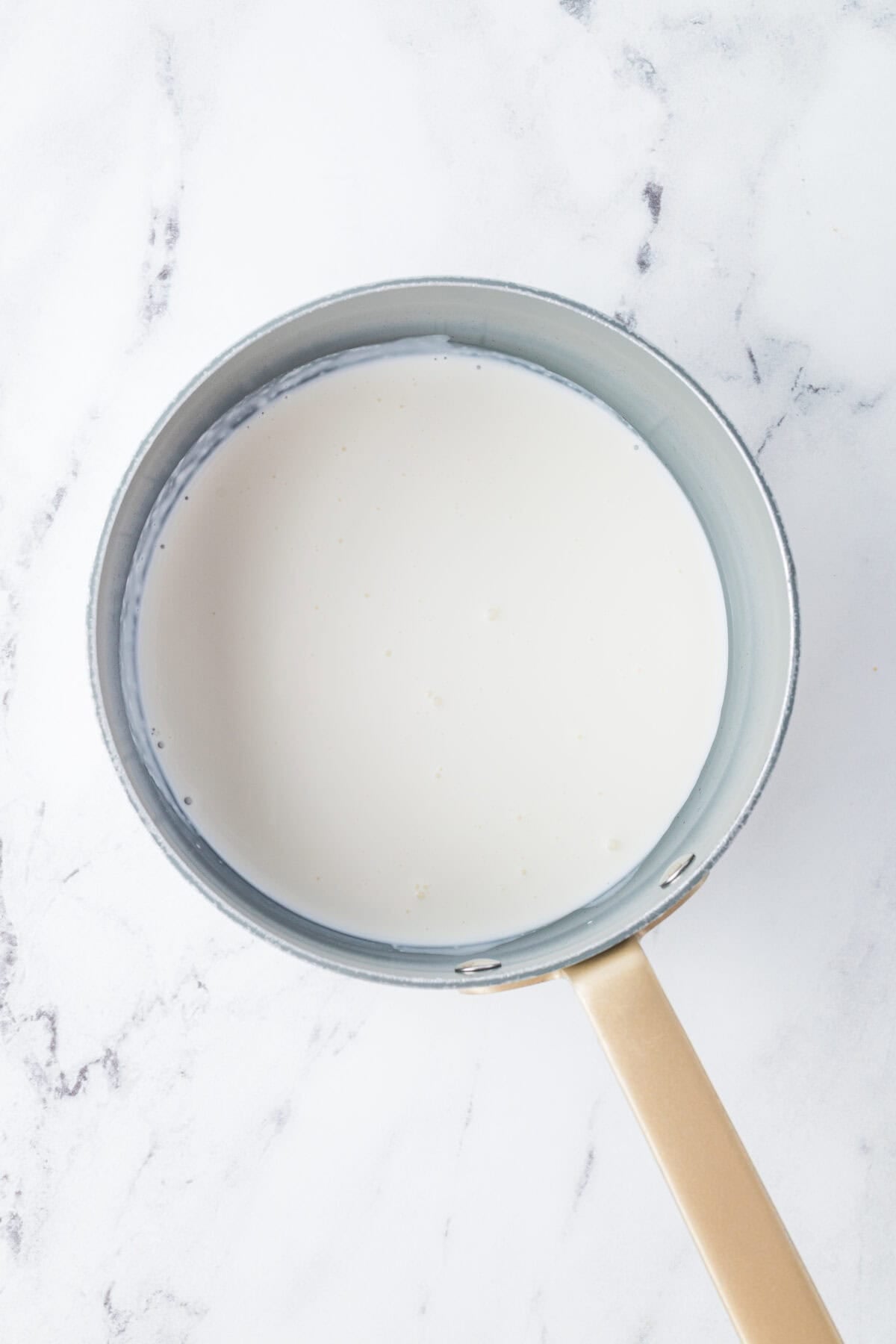 steaming heavy cream in a pot