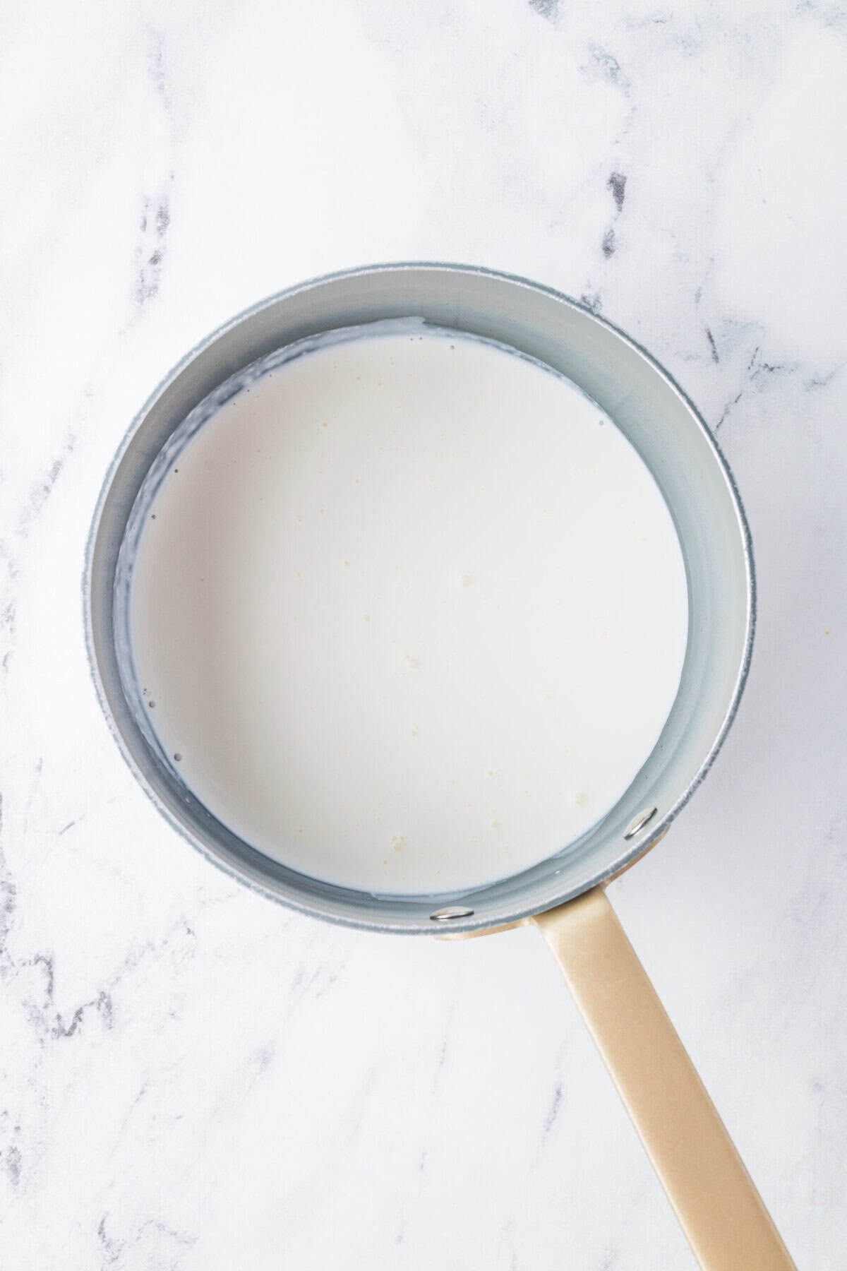 steaming heavy cream in a pot