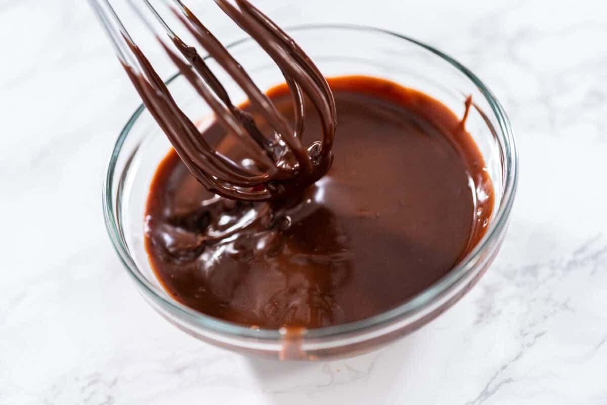 chocolate ganache in a bowl with a whisk