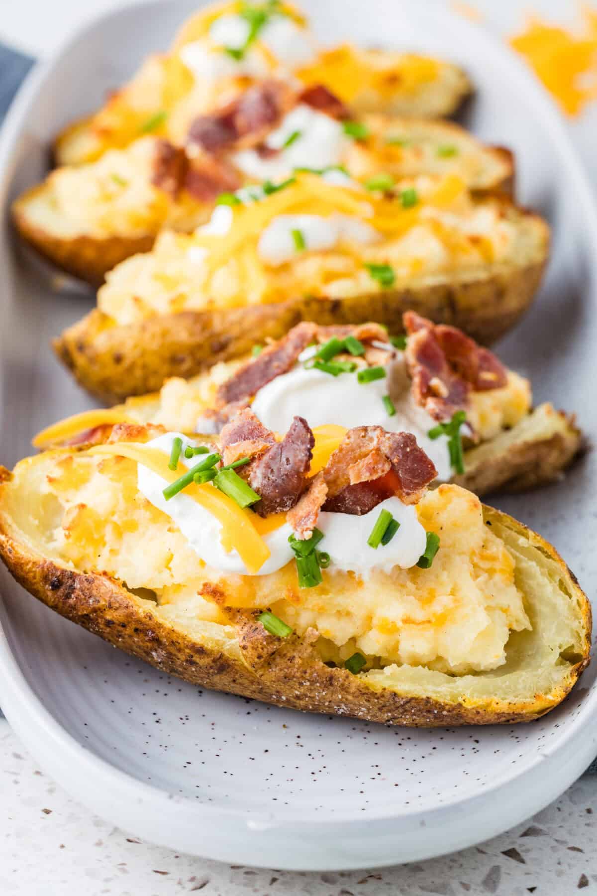 twice baked potato with sour cream, cheese and bacon pieces