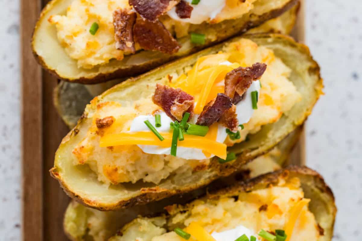 twice baked potato with sour cream, cheese and bacon pieces