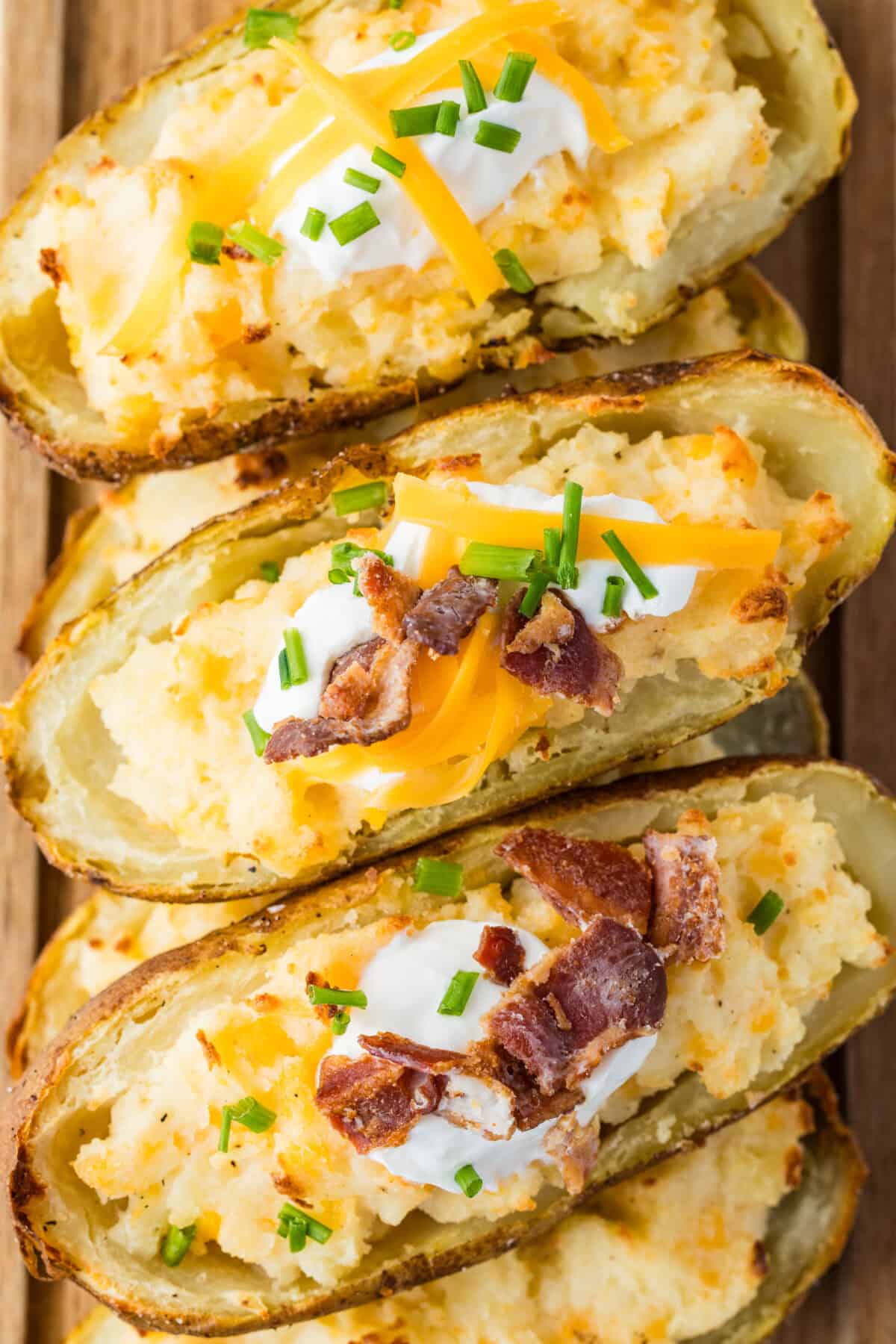twice baked potato with sour cream, cheese and bacon pieces