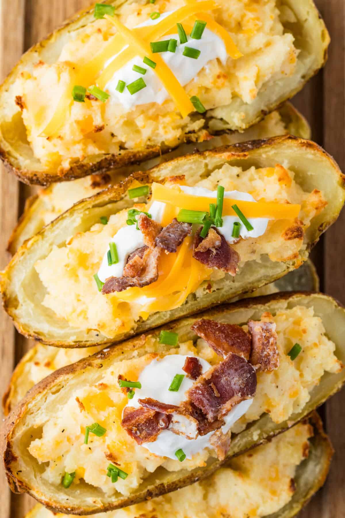 twice baked potato with sour cream, cheese and bacon pieces