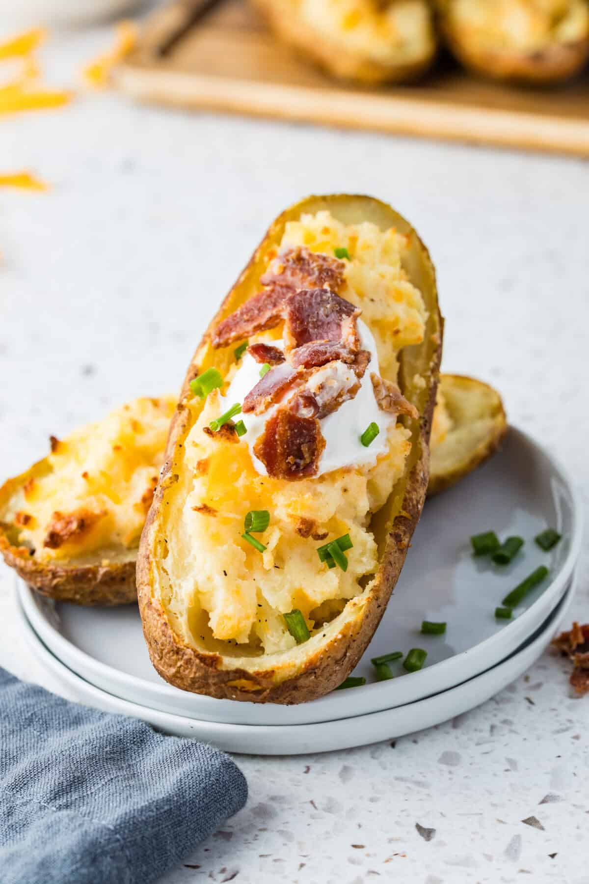twice baked potato with sour cream, cheese and bacon pieces
