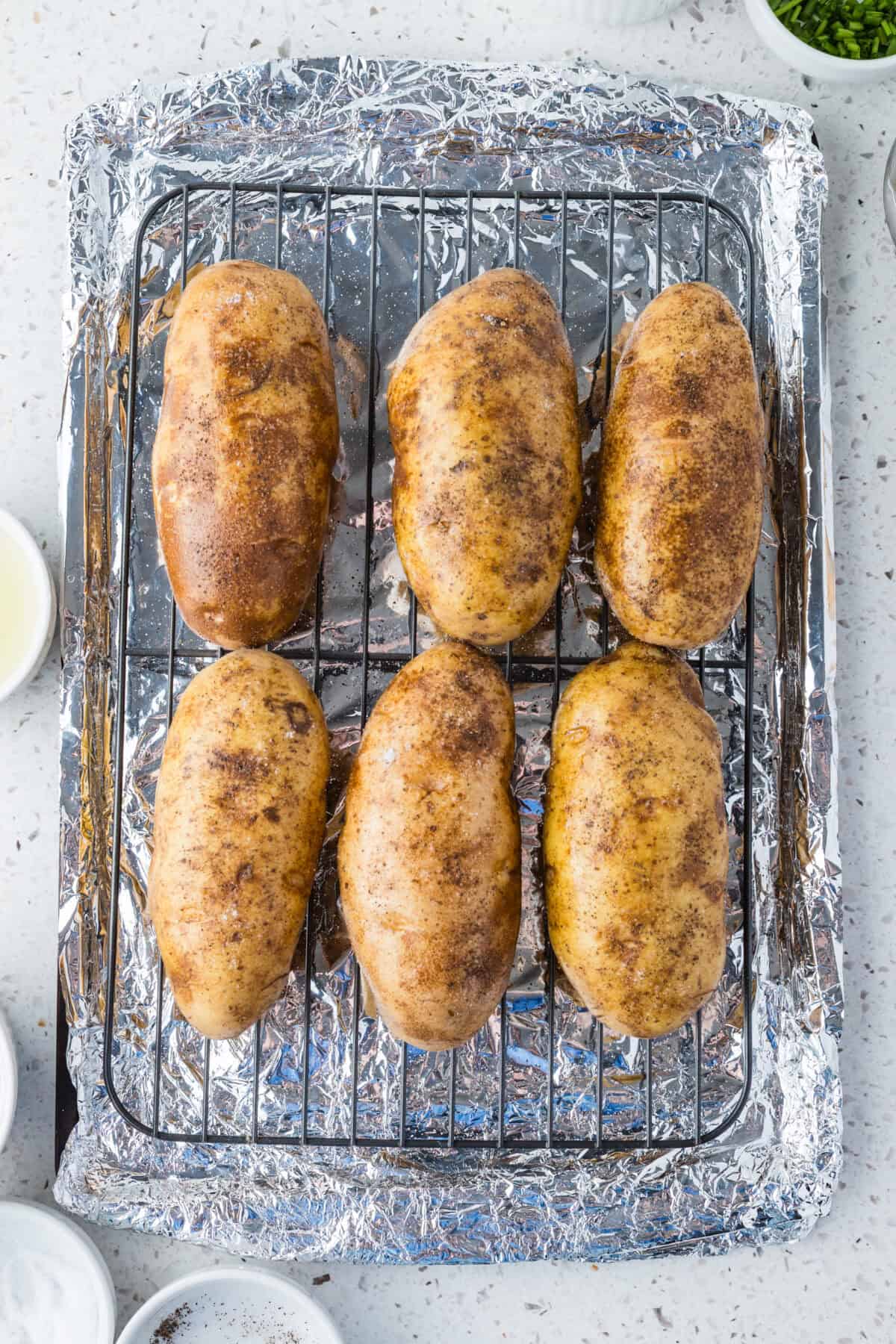 russet potatoes on baking sheet with wire rack