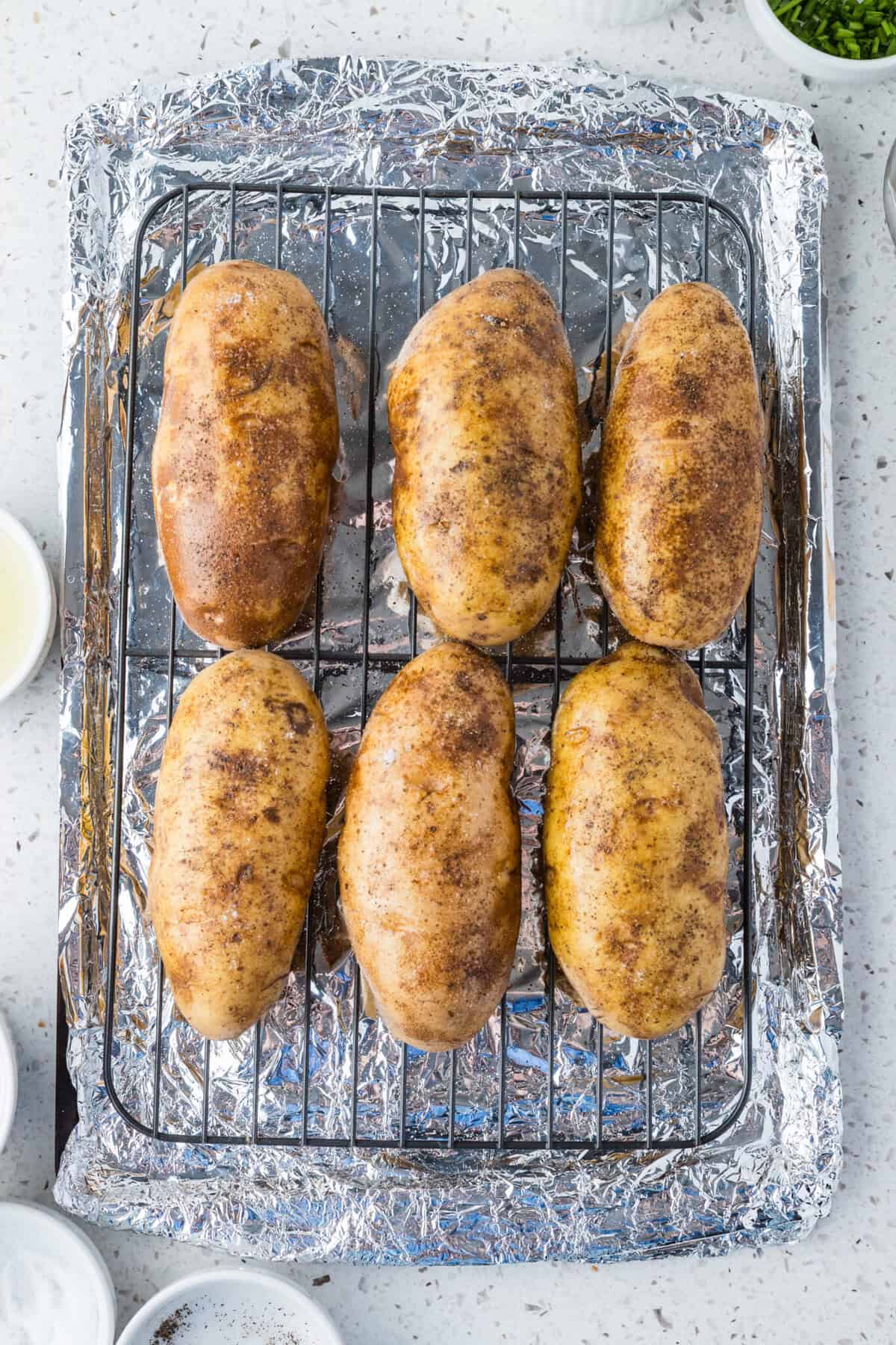 russet potatoes on baking sheet with wire rack