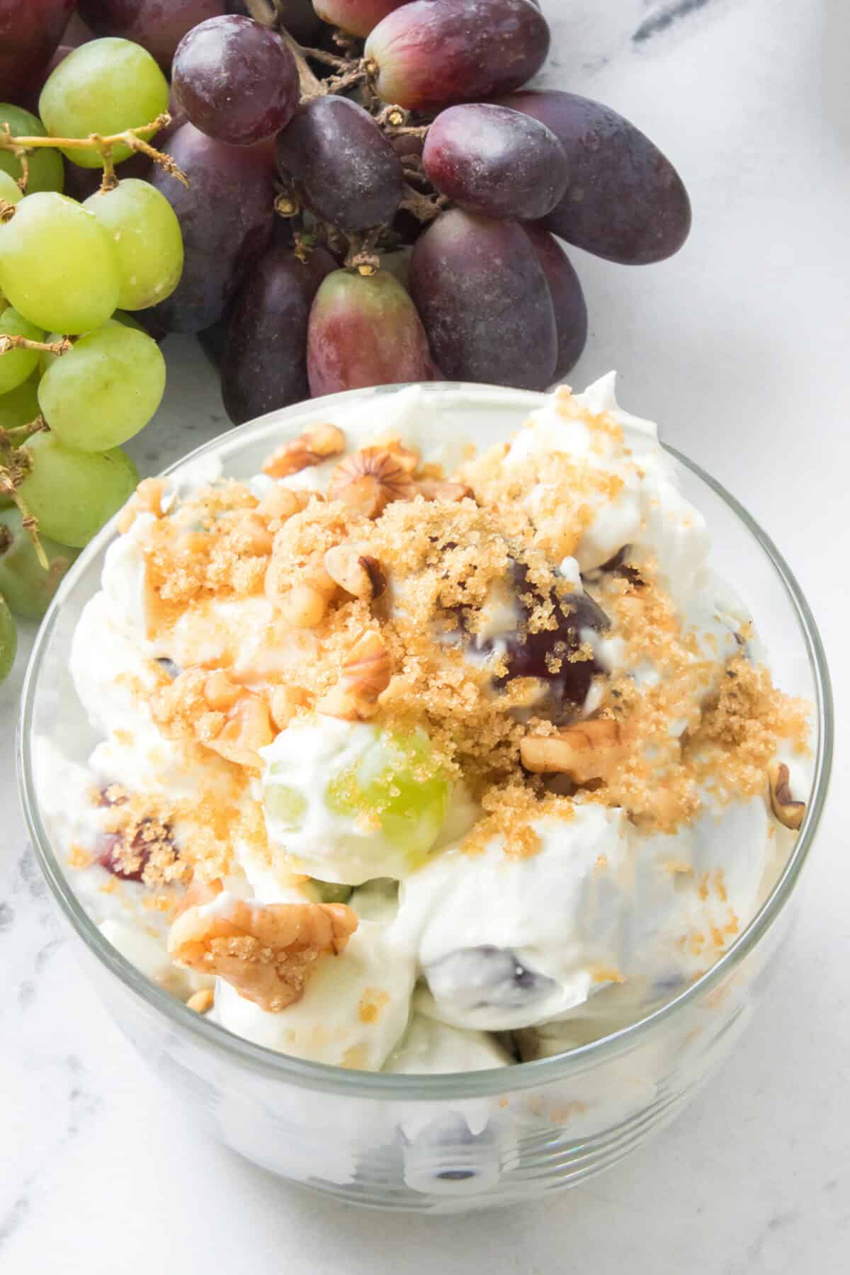 grape salad in a clear bowl with grapes on the side