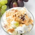 grape salad in a clear bowl with grapes on the side