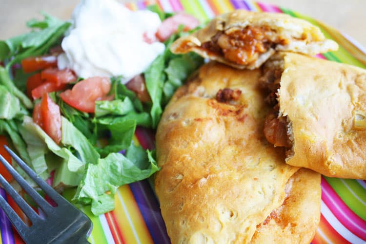 Salad and taco pockets on plate