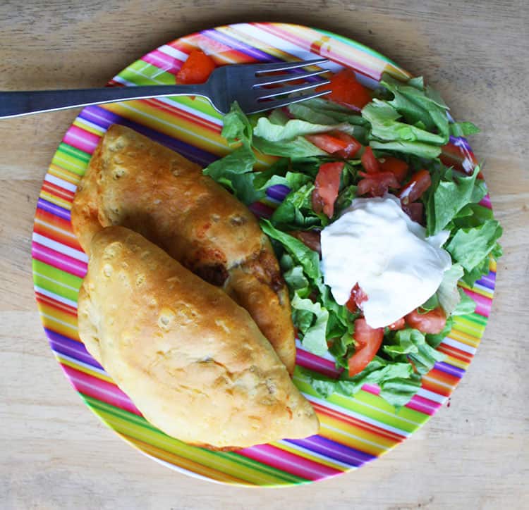 Taco Pockets and Salad on a striped plate