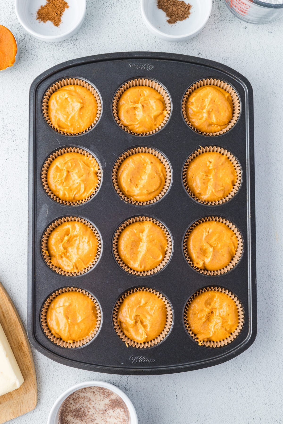 cupcake batter in liners in a pan