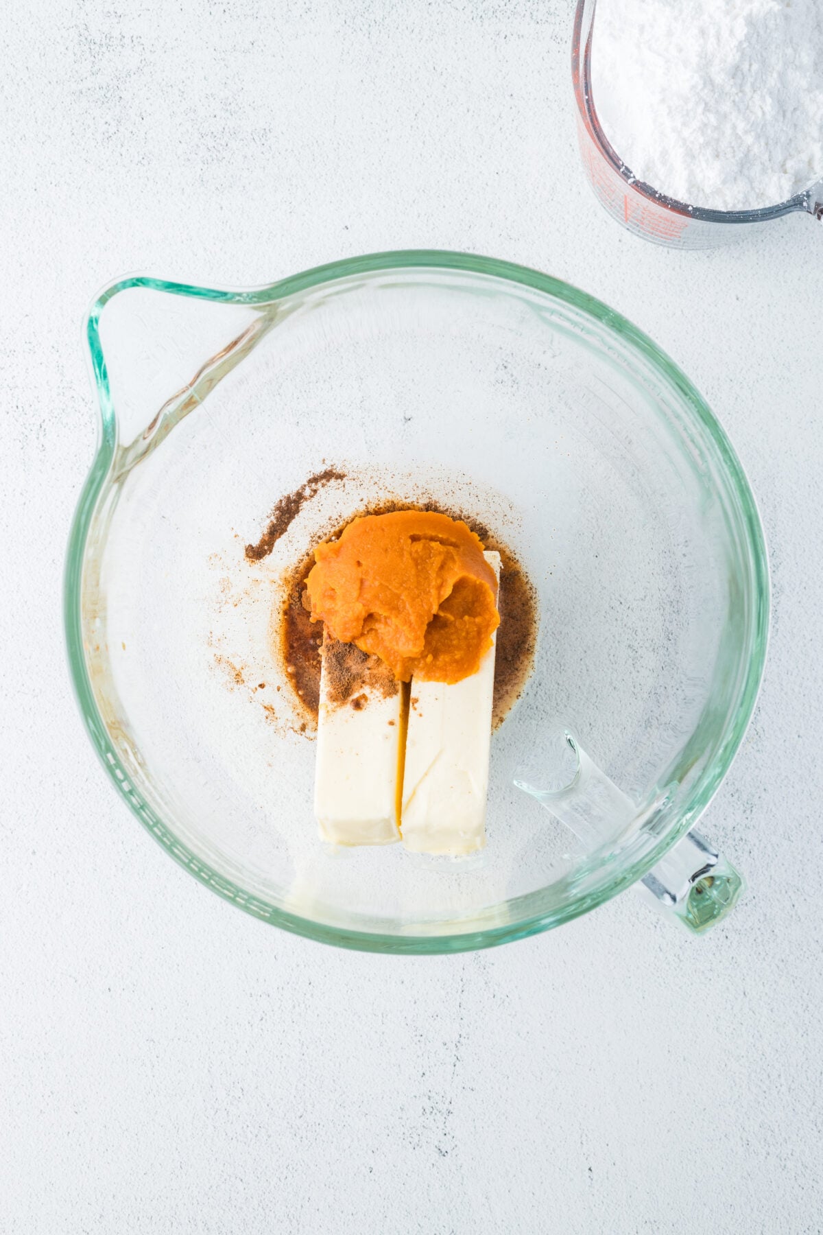 pumpkin spice buttercream ingredients in a mixing bowl