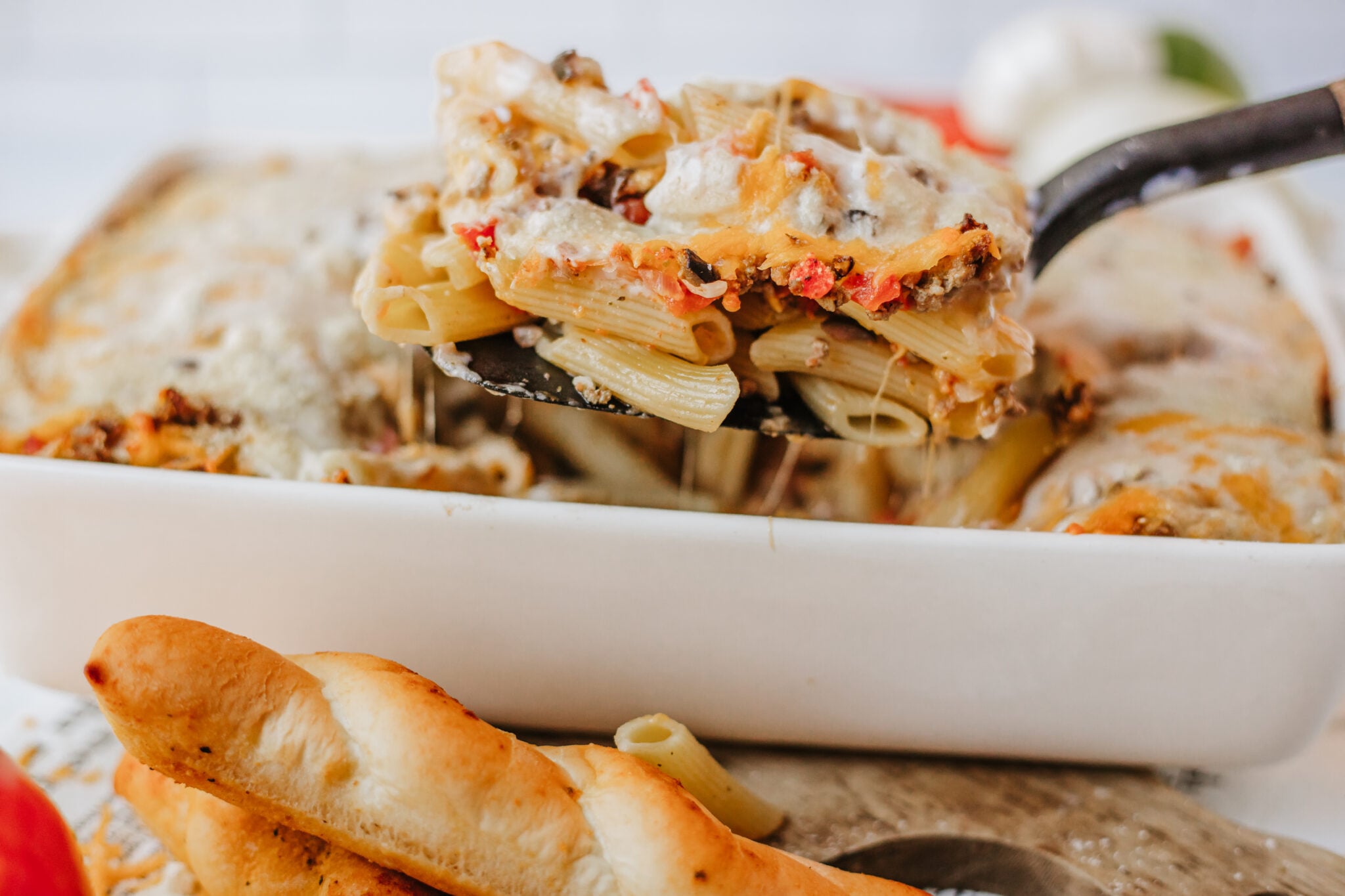dipping baked penne casserole out of dish