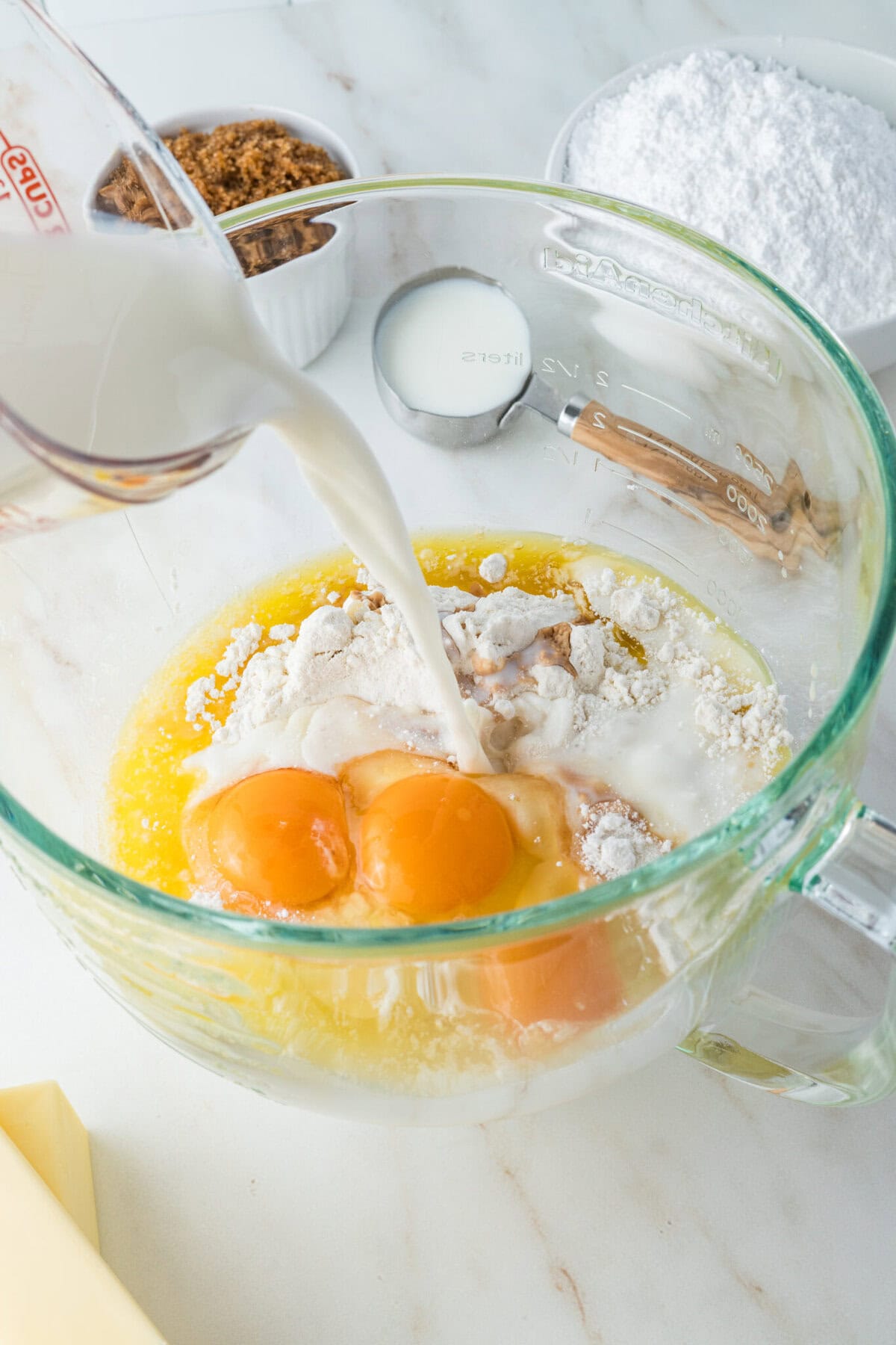 adding milk to cake batter for caramel cake