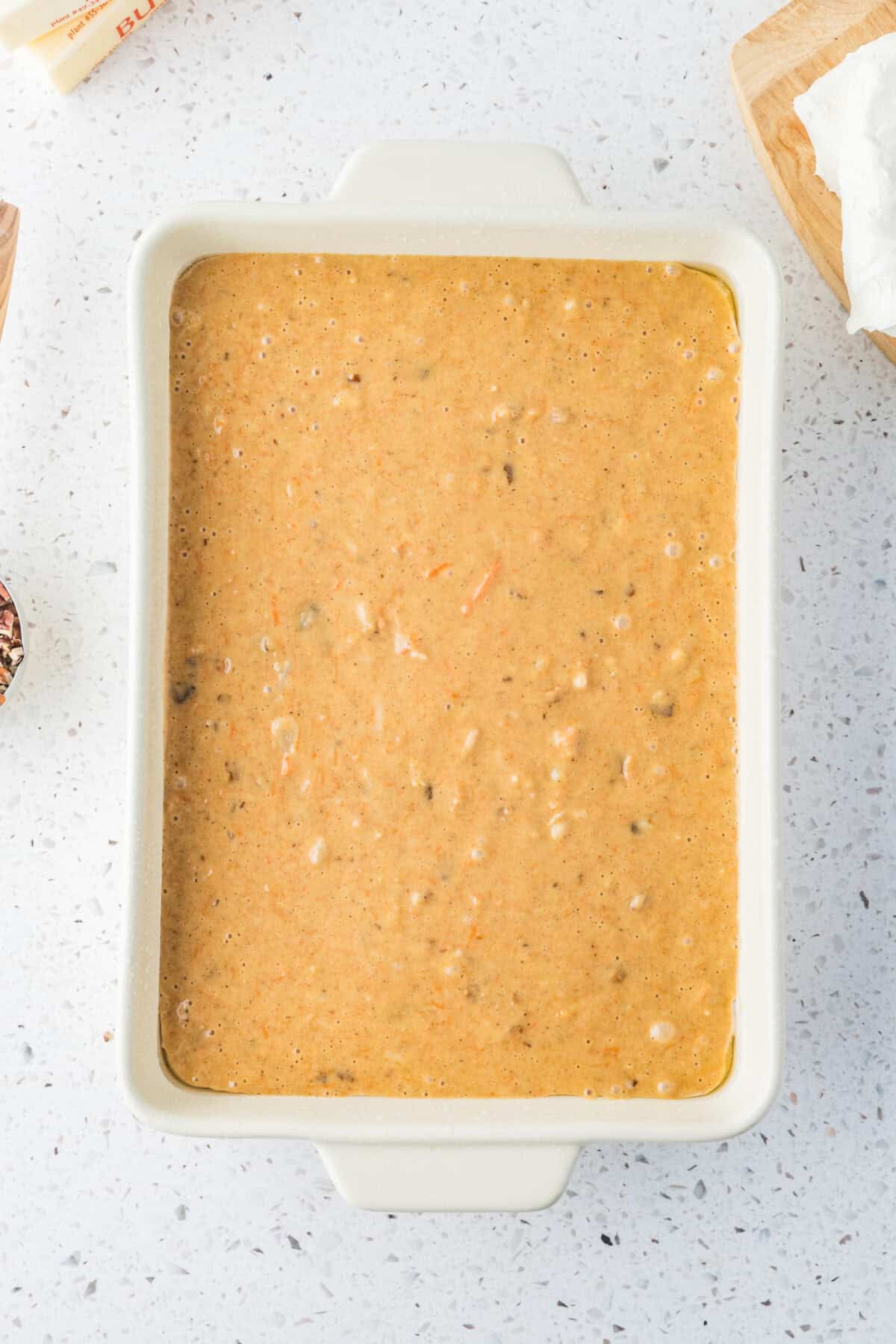 carrot cake batter poured into baking pan