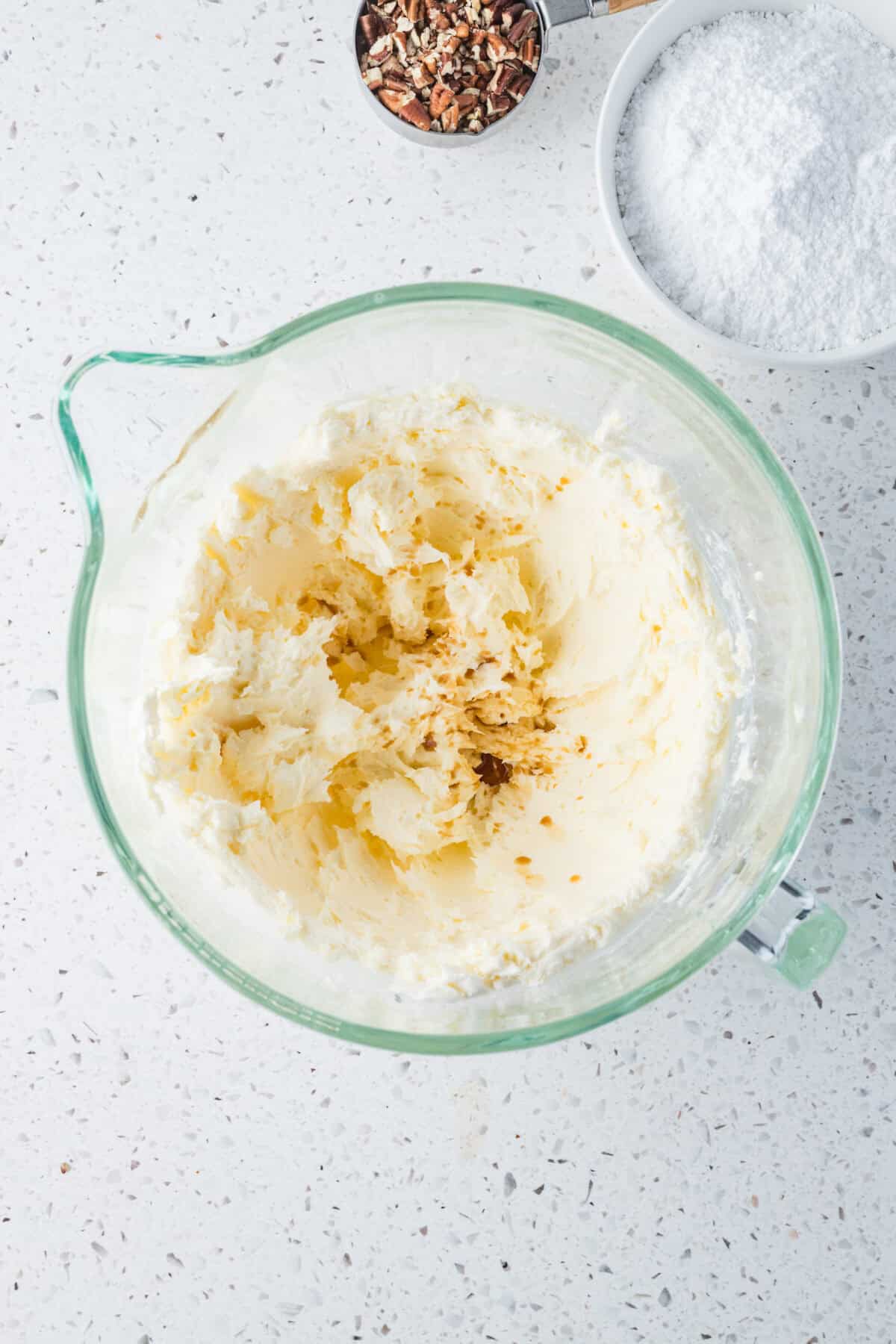 ingredients for cream cheese frosting in mixing bowl