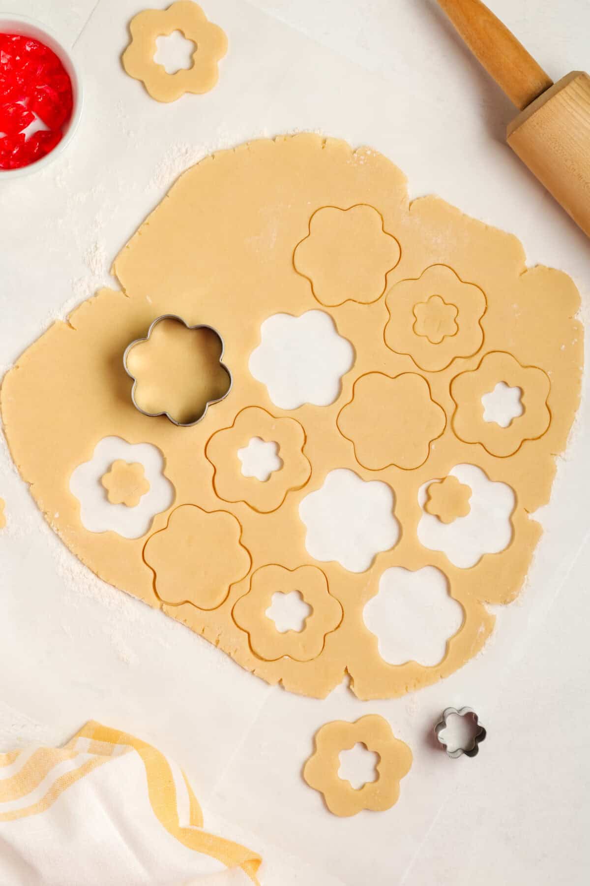 rolled out cookie dough with cookie shapes being cut out