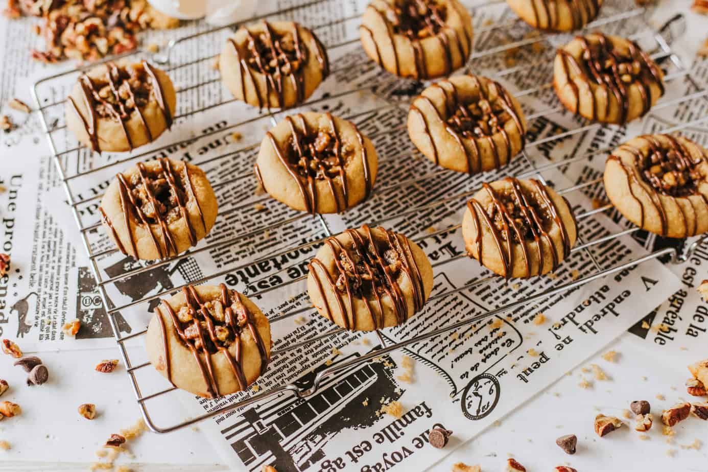 Pecan Pie Cookies on a wire rack over newsprint