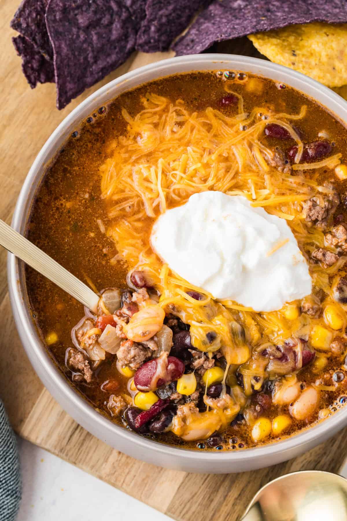 bowl of taco soup with sour cream and cheese
