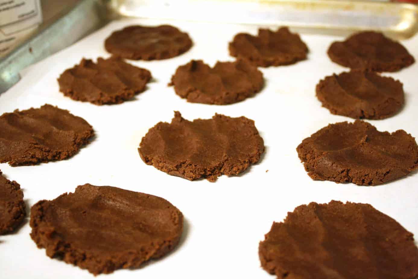 chocolate cookie dough flattened on parchment paper