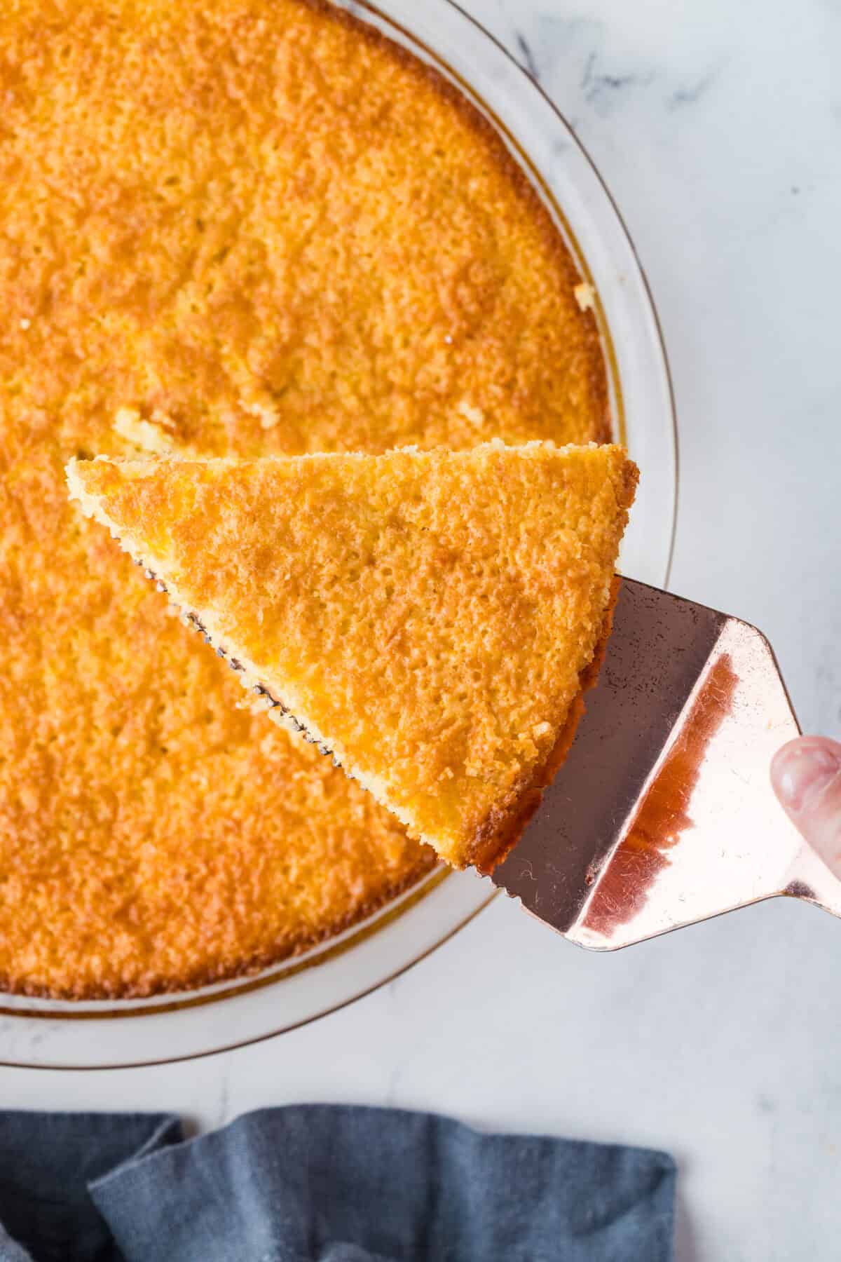 slice of buttermilk pie being cut out of whole pie