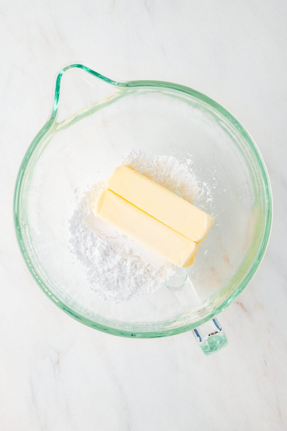 butter and powdered sugar in a mixing bowl