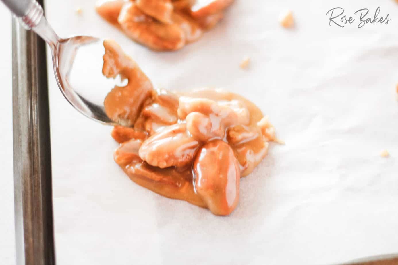 spooning the praline mixture on parchment paper 