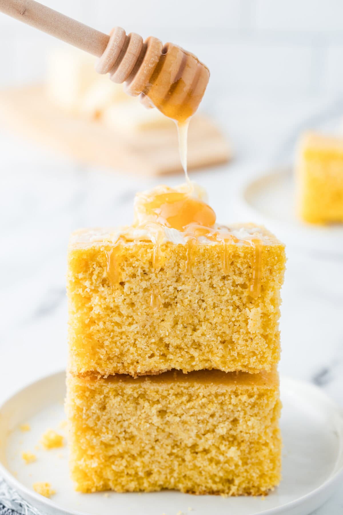 Southern Buttermilk Cornbread slices stacked with honey drizzle