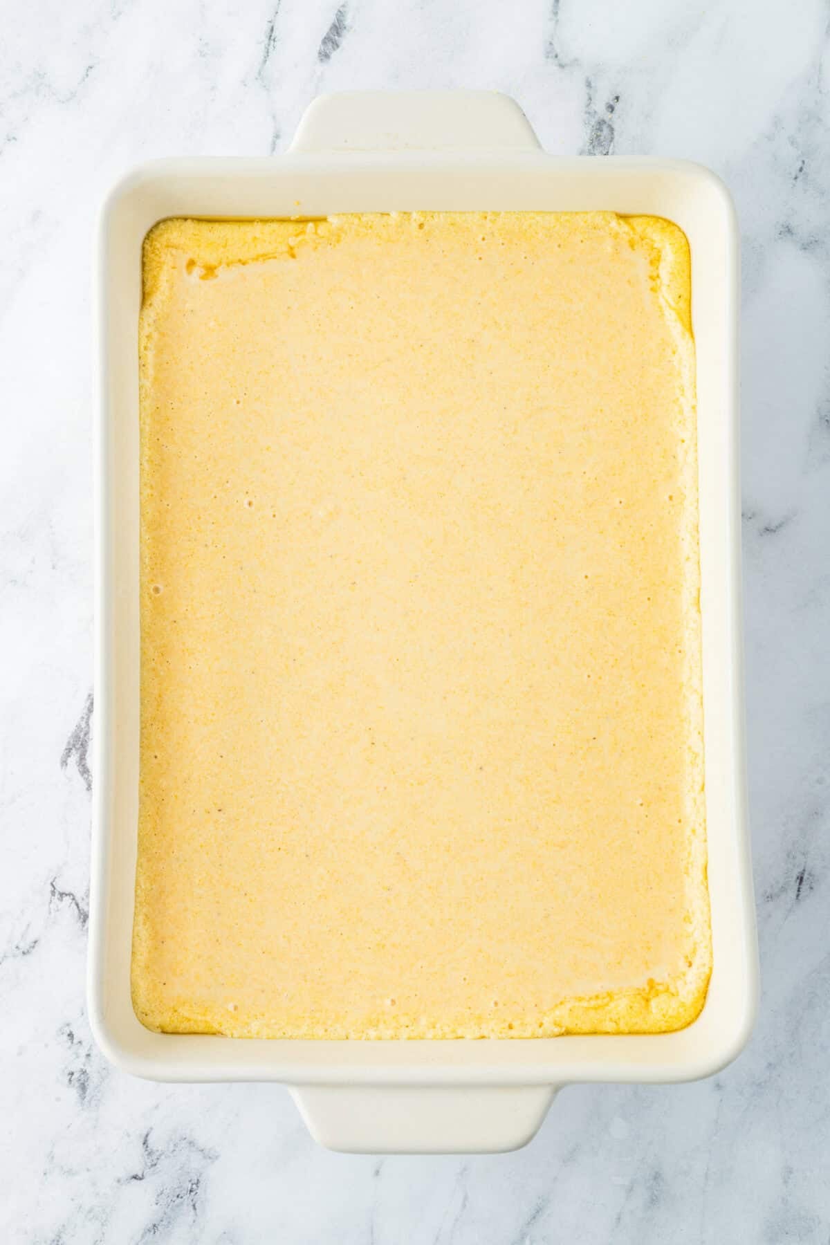 cornbread batter poured in hot 9x13 dish