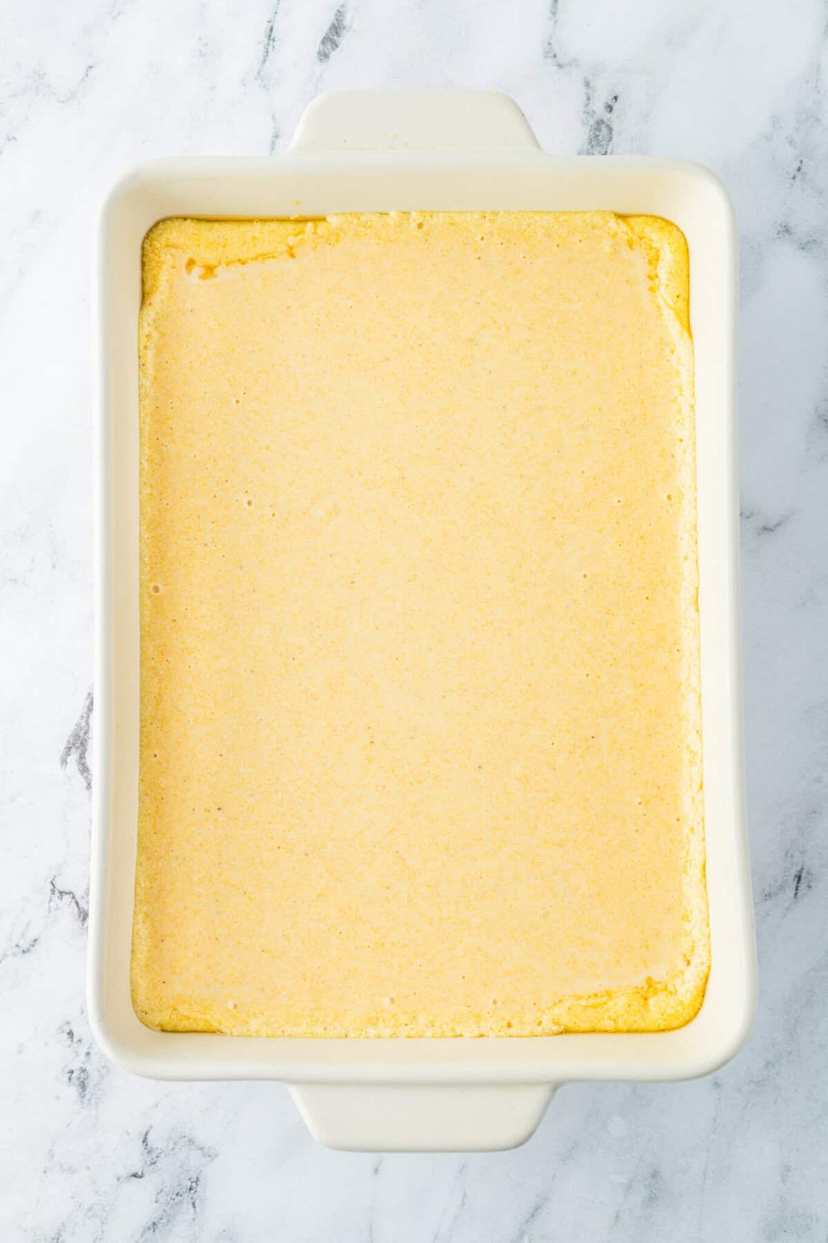 cornbread batter poured in hot 9x13 dish