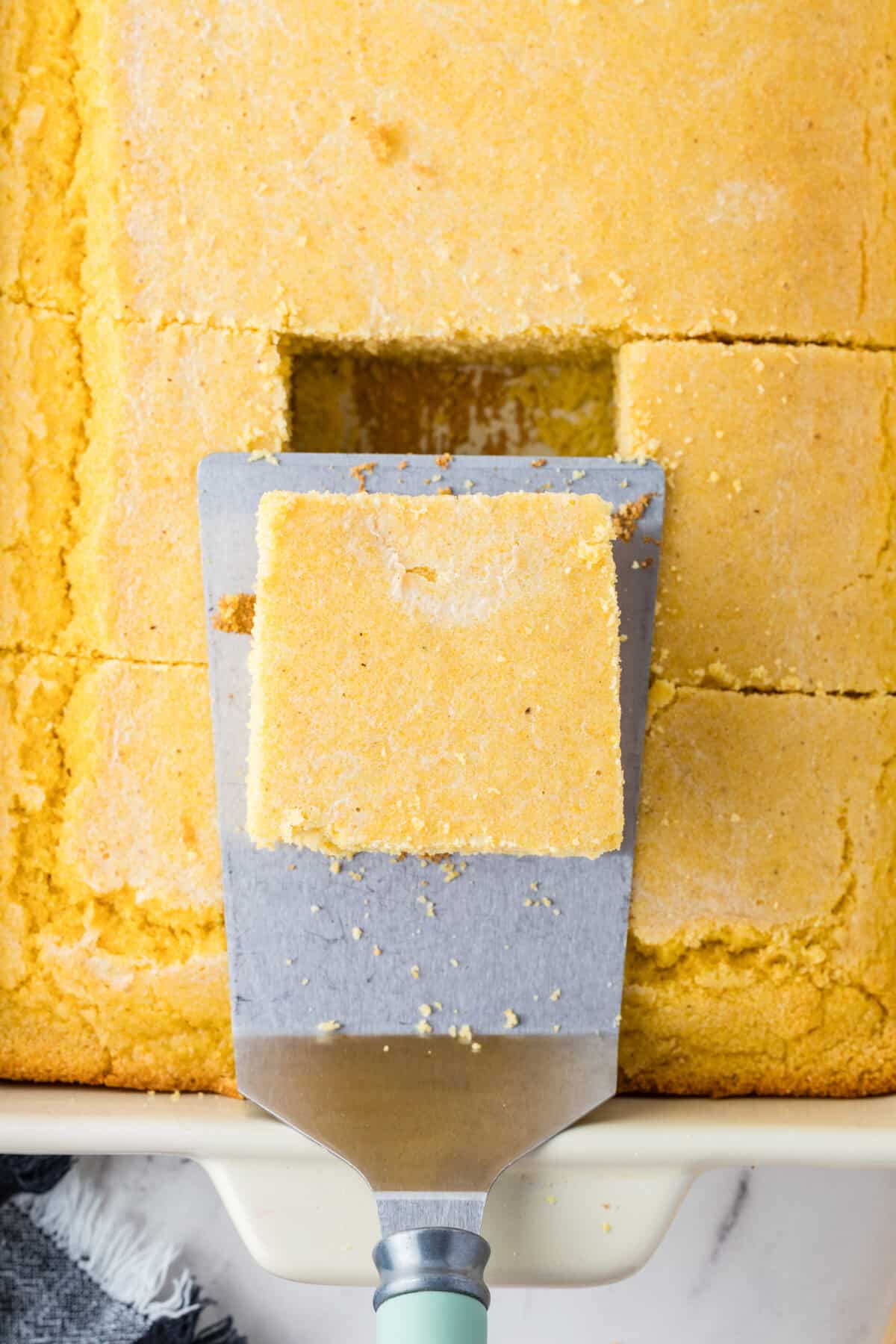 southern cornbread in a dish with a square cut out
