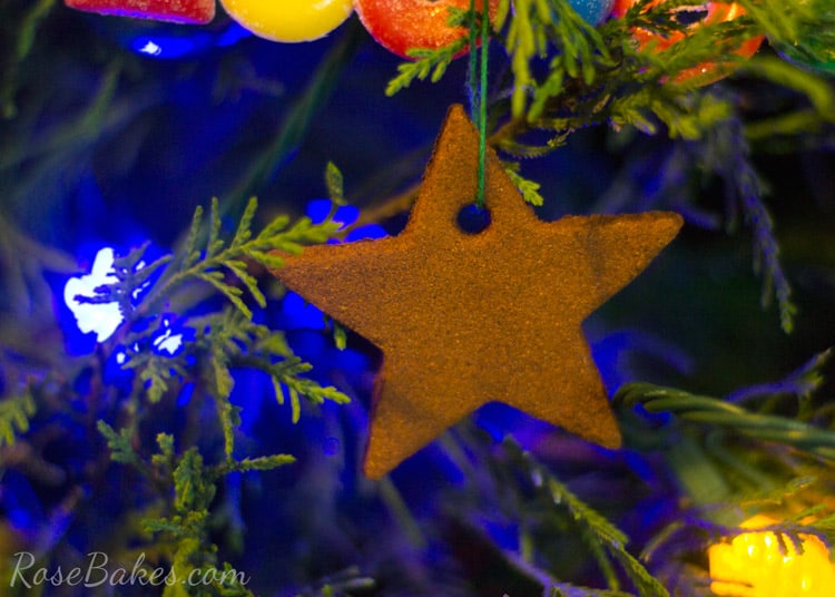 Cinnamon ornament hanging on Christmas tree with lights