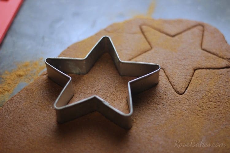 Cutting stars out of rolled out cinnamon dough for ornaments