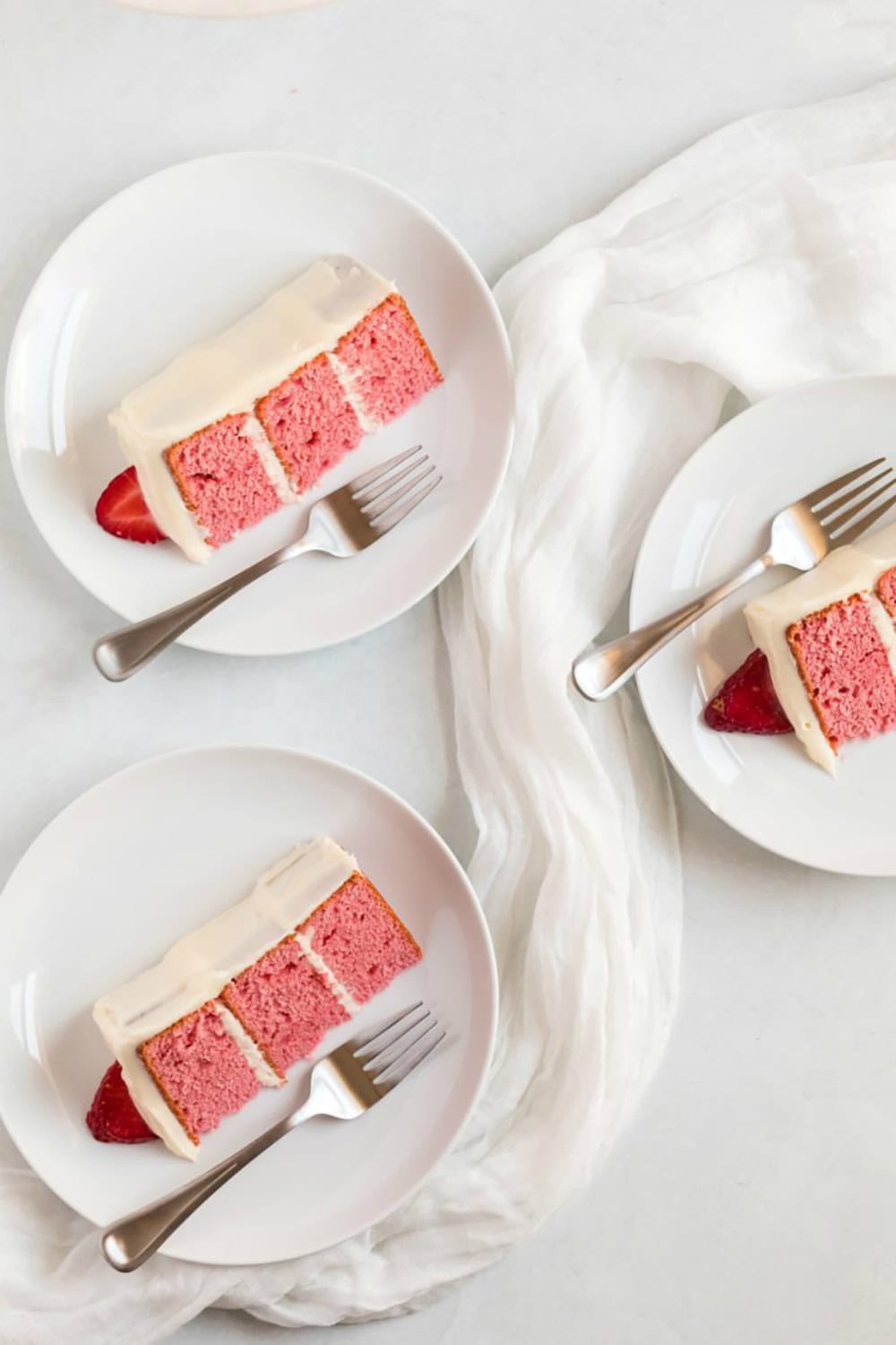 slices of strawberry cake on white plates