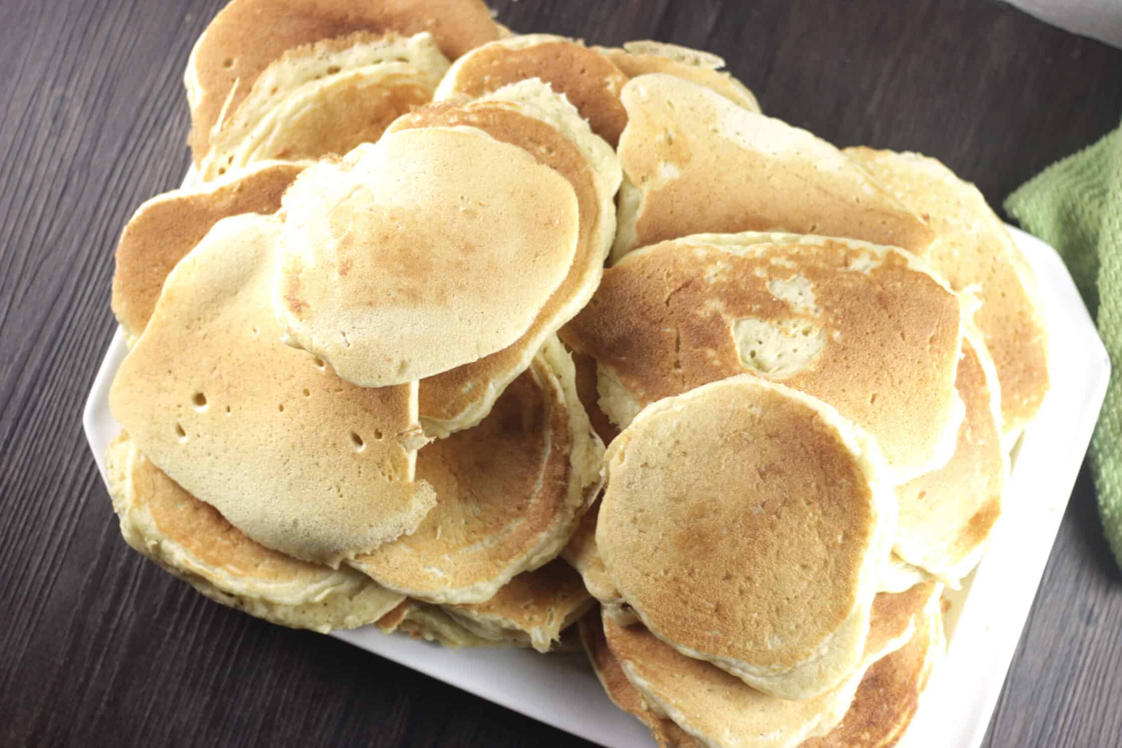 a pile of buttermilk pancakes on a platter