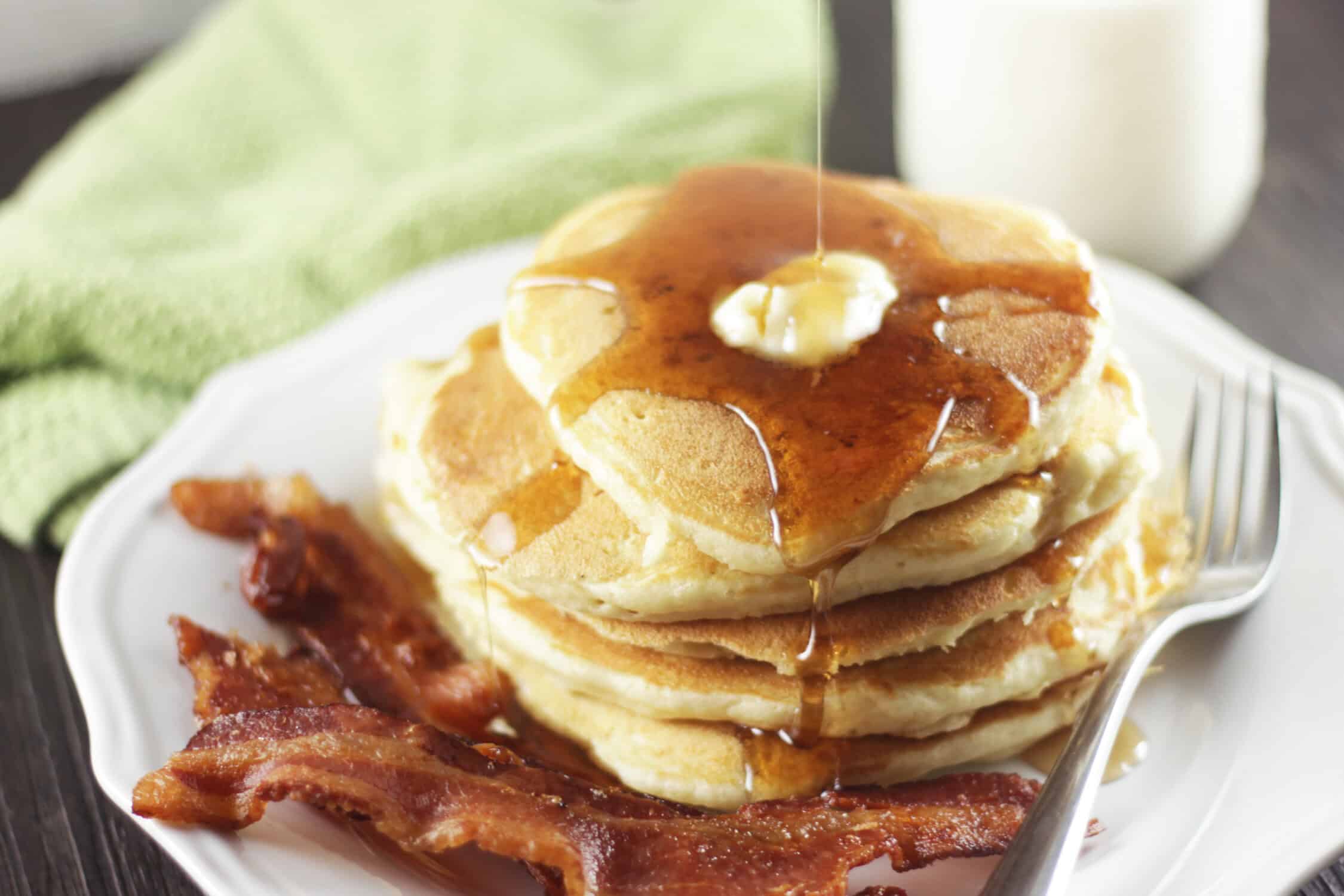 buttermilk pancakes with bacon on a plate