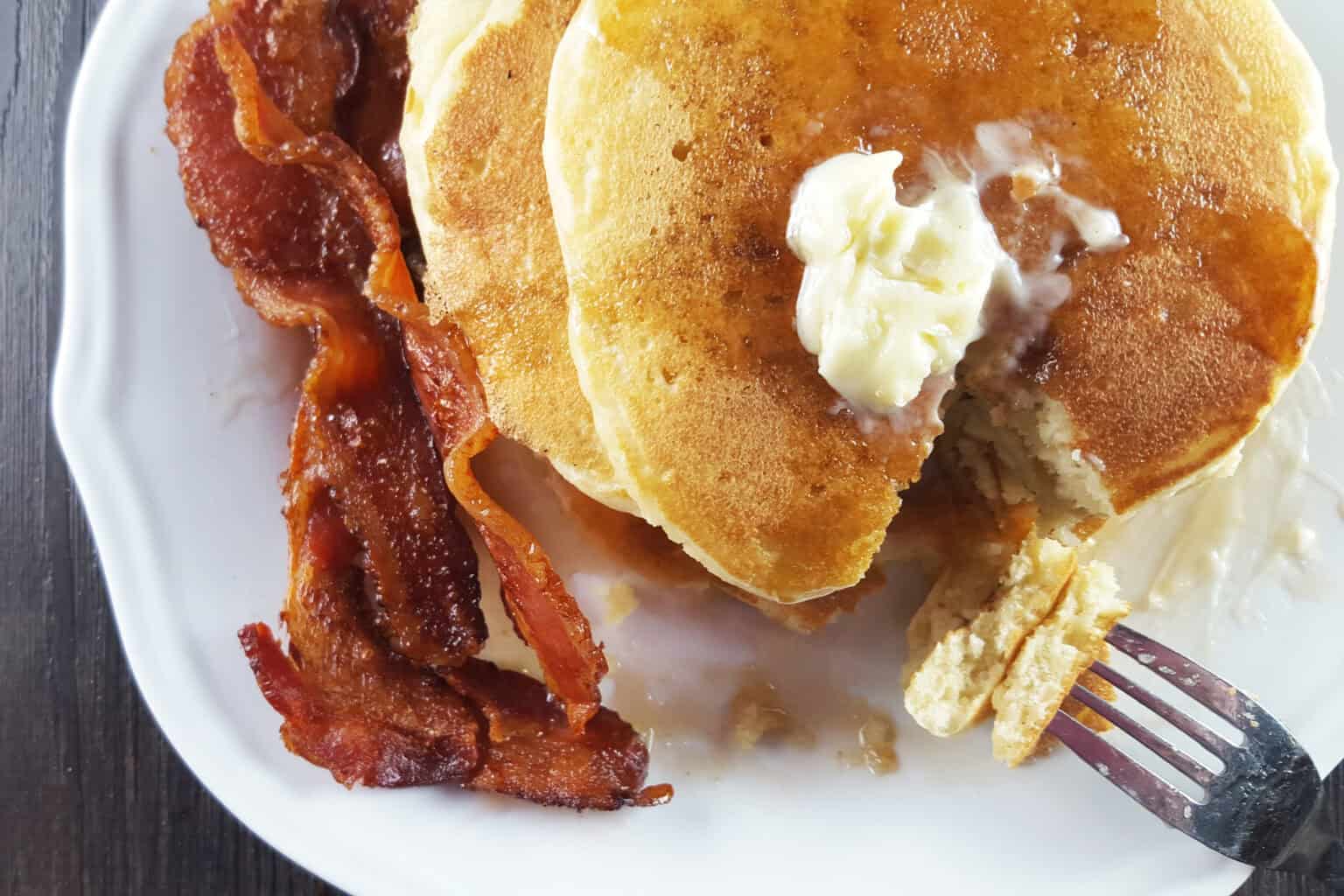 Fluffy Buttermilk Pancakes with Bacon on a white plate