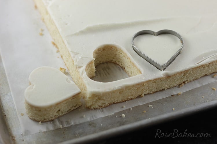 heart cakes cut from sheet of cake with heart cookie cutter