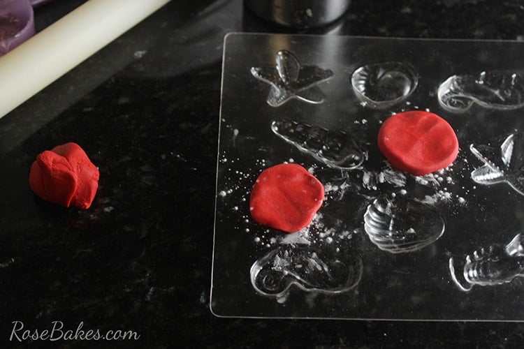 Press fondant into candy mold