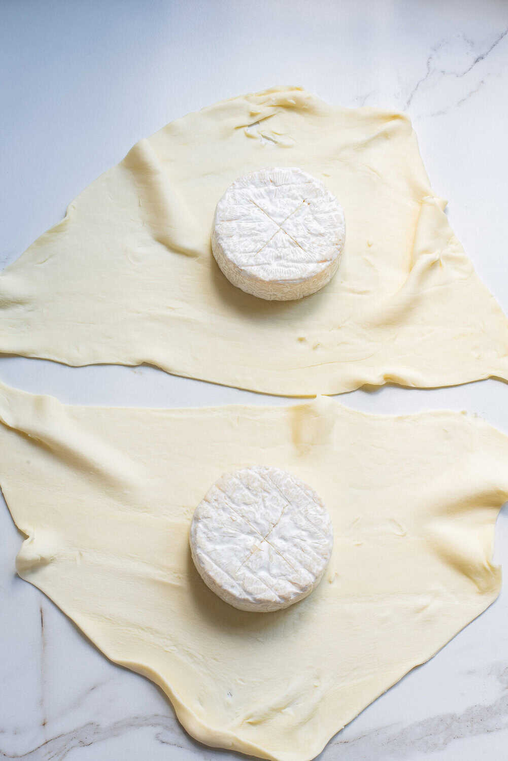 puff pastry with wheels of brie that have been slit on top