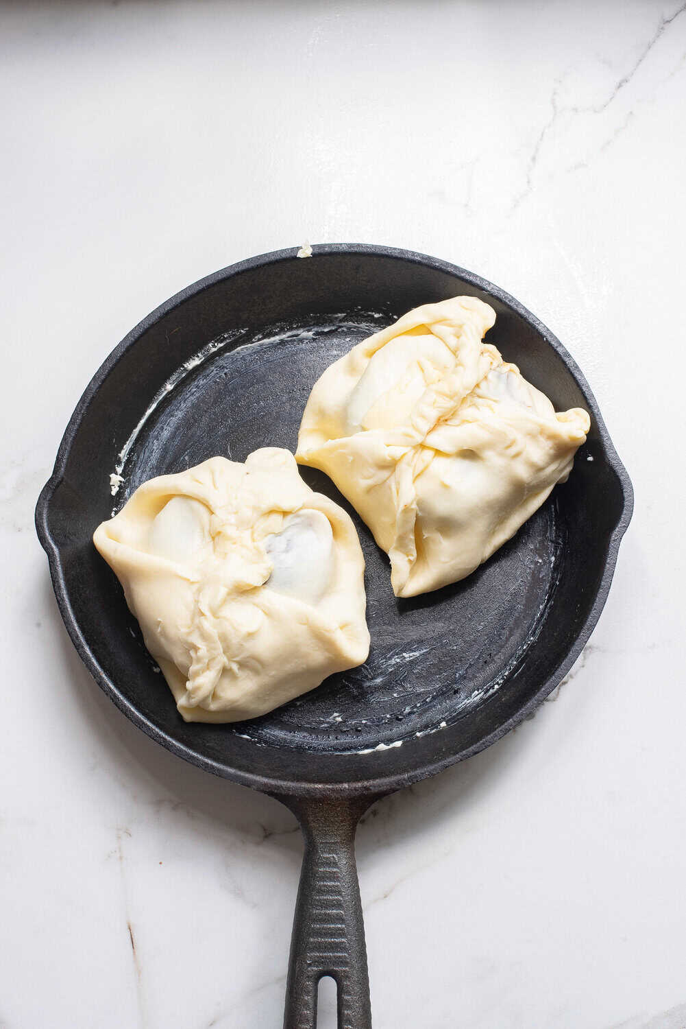 brie wrapped in puff pastry in a skillet