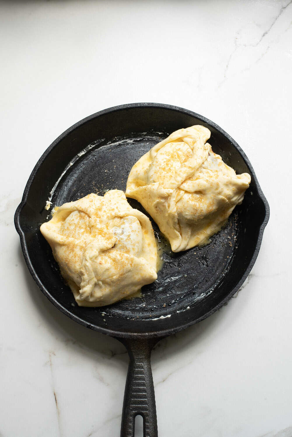 brie wrapped in puff pastry, brushed with egg wash and sugar sprinkled on top with thyme